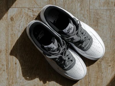 Close up on comfortable sports shoes on a light gray floor.